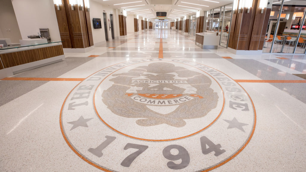 Interior photo of the Studet Union building, a long hallway with the crest of the University of Tennessee in the forefront.